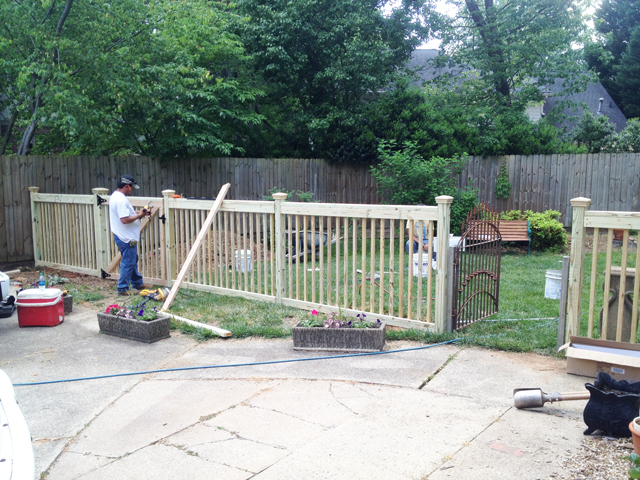 Fence posts are complete and pickets are in place for fence in front of driveway