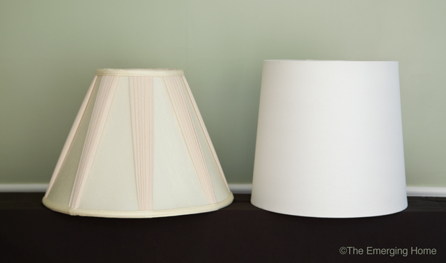 a pleated, cream colored, bell shaped lampshade sits beside a white drum drum shaped lampshade