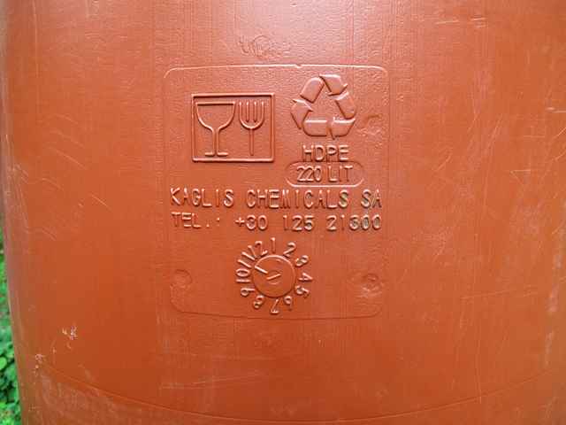 close-up of a stamp on water barrel indicating food grade quality symbols