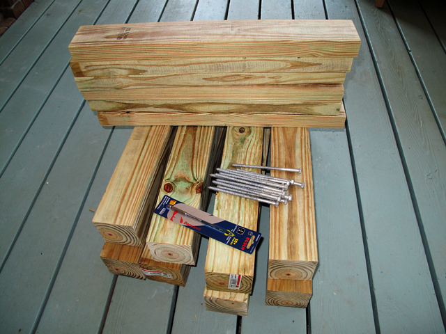 two-by-four and four-by-four wood planks are cut and stacked 