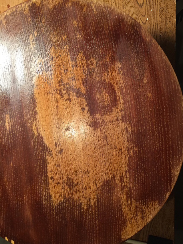 Closeup photo of patchy coloration on table during bleaching process 