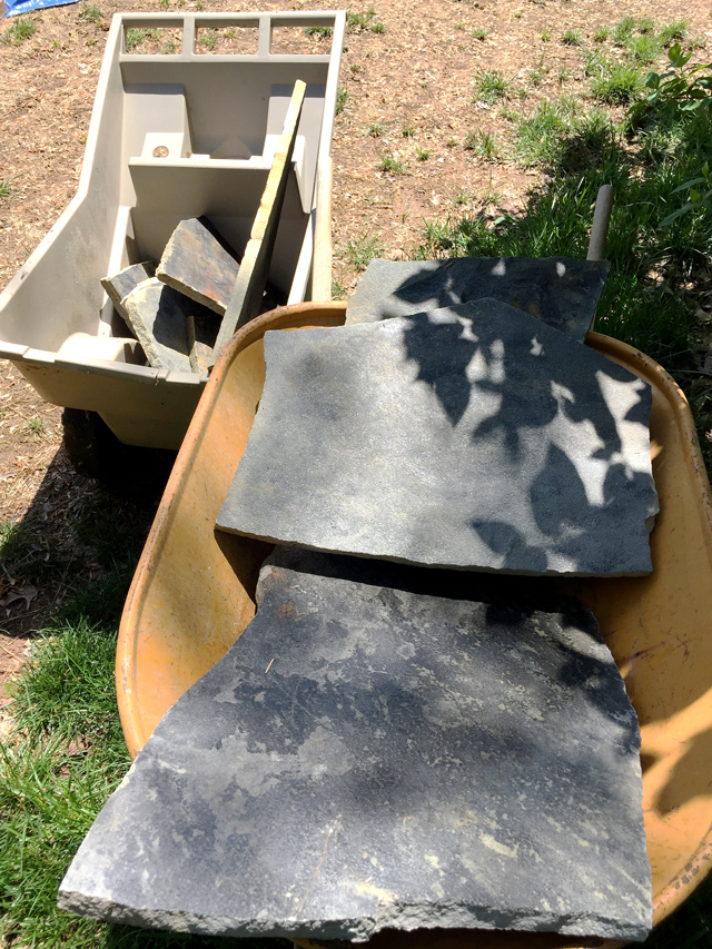 2 large gray flagstones in wheelbarrow