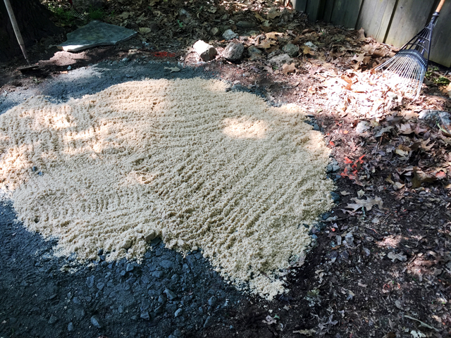 Leveling sand is added to top of granite base before flagstones