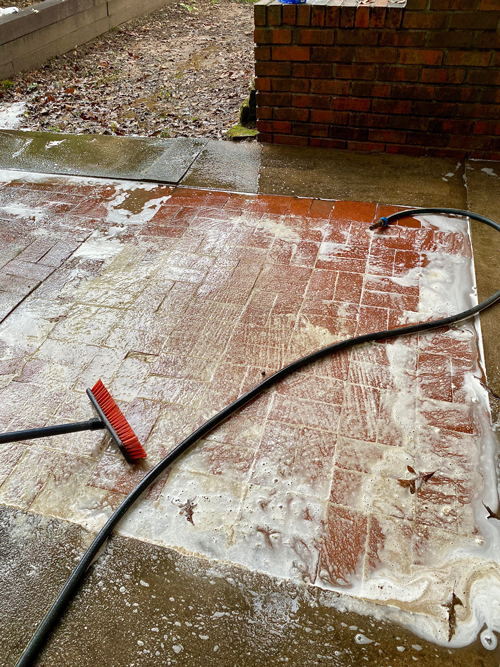 soap foam on patio during cleaning process