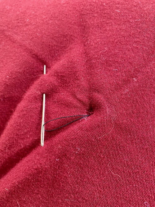threaded needle in pillow