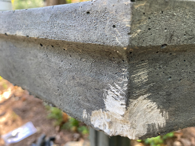 Closeup of damage to concrete birdbath