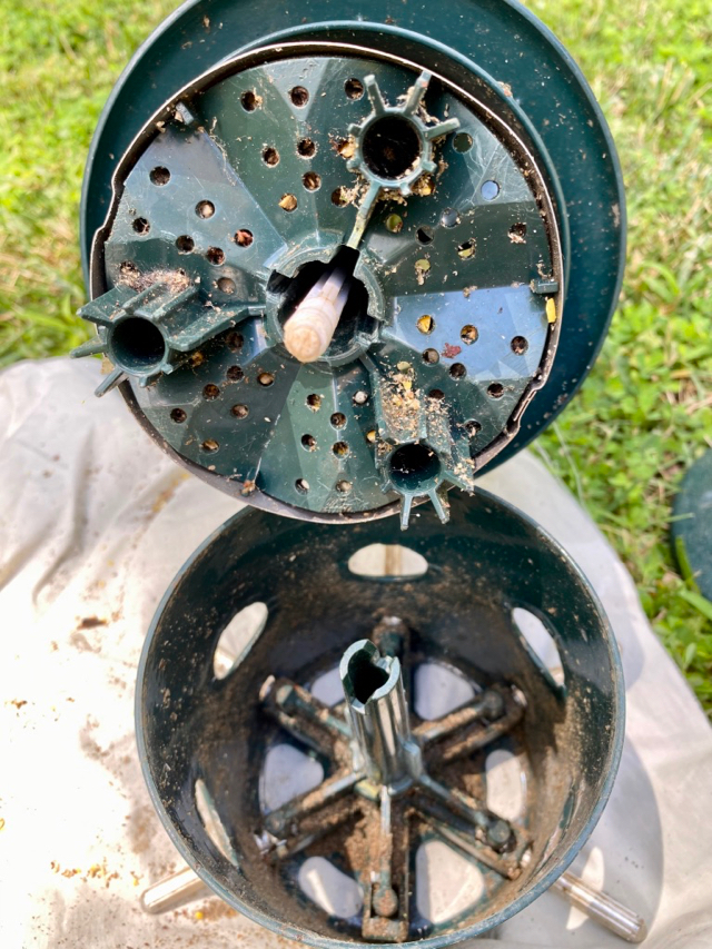 old birdseed stuck in metal parts of feeder