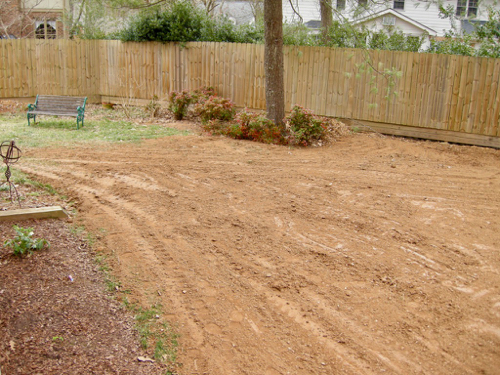 soil is spread over one side of yard