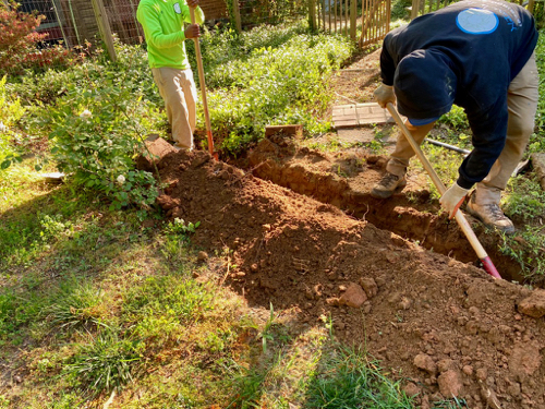 ditch digging is completed near sidewalk and popup drain