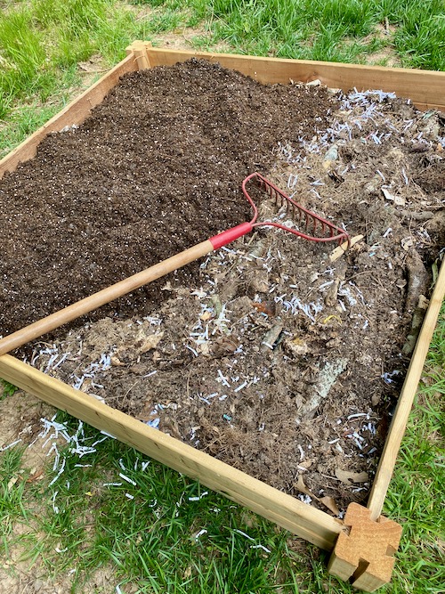 adding garden soil as top layer of raised bed 