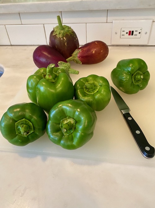 whole green peppers and eggplant on counter