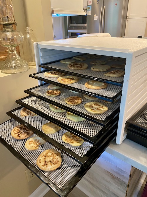 eggplant slices laid on 6 stacked dehydrator trays with space for air flow in between
