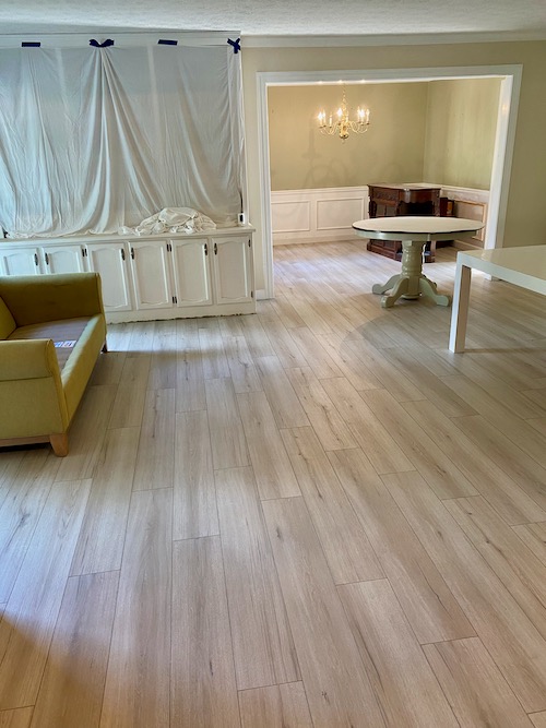 White and gray wide-plank flooring is installed in living room