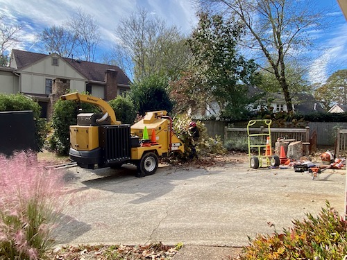 Chipper/shredder sits in driveway to shred tree limbs and branches